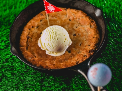 The Cookie Skillet: a warm chocolate chip cookie topped with vanilla ice cream and a Pine Royale flag