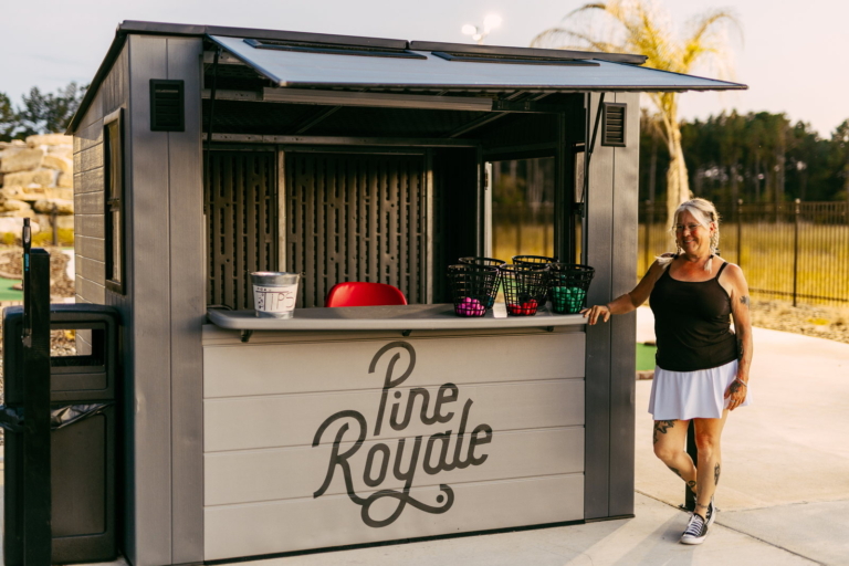 An attendant at the Mini Royale starter hut at Pine Royale, ball baskets on the counter